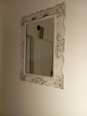 a mirror on the wall above a sink in a bathroom