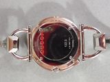 a close up of a wrist watch with a red and black face