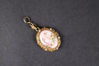 a close up of a gold and pink locke with a picture on it