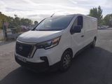the white van is parked on the side of the road