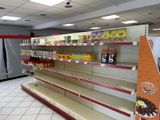 many empty shelves in a grocery store with food on them