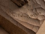 a close up of a piece of wood with writing on it