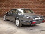 an image of a car parked in front of a brick wall