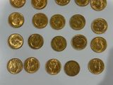 a lot of gold coins sitting on a white surface