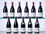 six bottles of red wine are lined up on a shelf