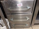 a silver oven sitting in the middle of a kitchen