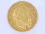 gold coin with a portrait of a man on the front