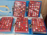 several boxes of buttons are sitting on a table in a room