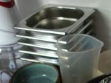 many bowls and pans sitting on the counter
