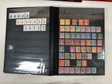 a lot of stamps on a folder on the table