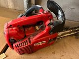 a chainsaw sitting on the floor in the garage