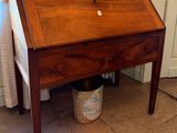 a small wooden desk with a drawer underneath it