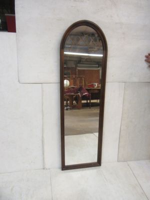 a mirror that is sitting on a wall in a room