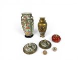 three vases and a bowl sitting next to each other