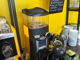 a coffee machine sitting on a counter in a coffee shop