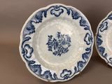 pair of blue and white plates with floral designs on them