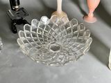 a glass bowl that is sitting on a table next to other glassware