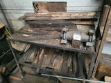 a pile of wood and a machine in a garage