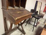 an old wooden desk with a book on top of it