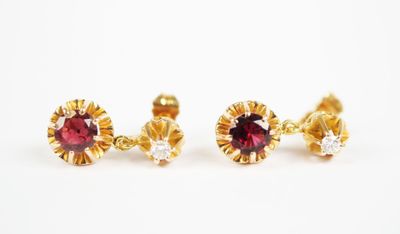 a pair of ruby and diamond earrings