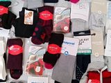 many pairs of men ' s socks on display in the store