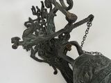 a bell hanging from a chain on a wall