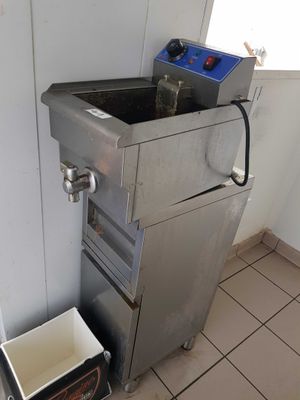 an image of a kitchen with a sink and a trash can