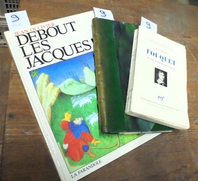 three books sitting on a table next to each other