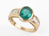 an emerald and diamond ring with baguets