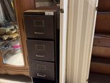 a tall cabinet with drawers and a mirror in the corner