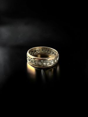 a close up of a gold ring on a black surface