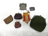 several different purses are sitting on a white surface