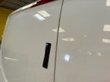 a close up of a door handle on a white van