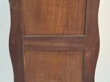 a small wooden cabinet with a door on top of it
