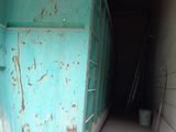a blue refrigerator that is in the middle of a building