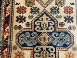 a close up of a rug on a wooden floor with a cat sleeping on the floor