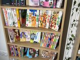 a book shelf with many books on it in a room