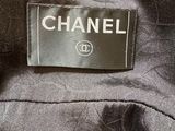 a close up of a chanel label on a black jacket