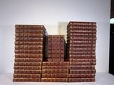 many books stacked on top of each other on a table
