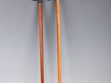 a pair of walking sticks with wooden handles on a white background