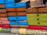 many boxes of cookies stacked on top of each other