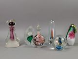 five glass vases sitting next to each other on a table