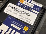 two memory cards sitting on top of a plastic container