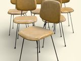 several chairs are lined up in a circle on a white surface