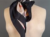 black and white checkered scarf on a mannequin mannequin torso