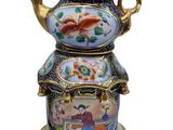 an image of a decorative teapot on a stand