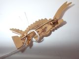 a wooden bird with a string attached to it ' s back