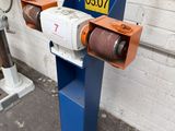 a machine that is sitting on the ground next to a wall