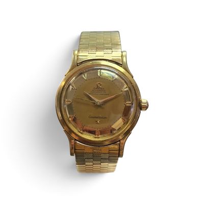 an image of a gold wrist watch with roman numerals on the face