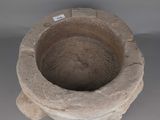 a stone bowl with a tag on it sitting on a table